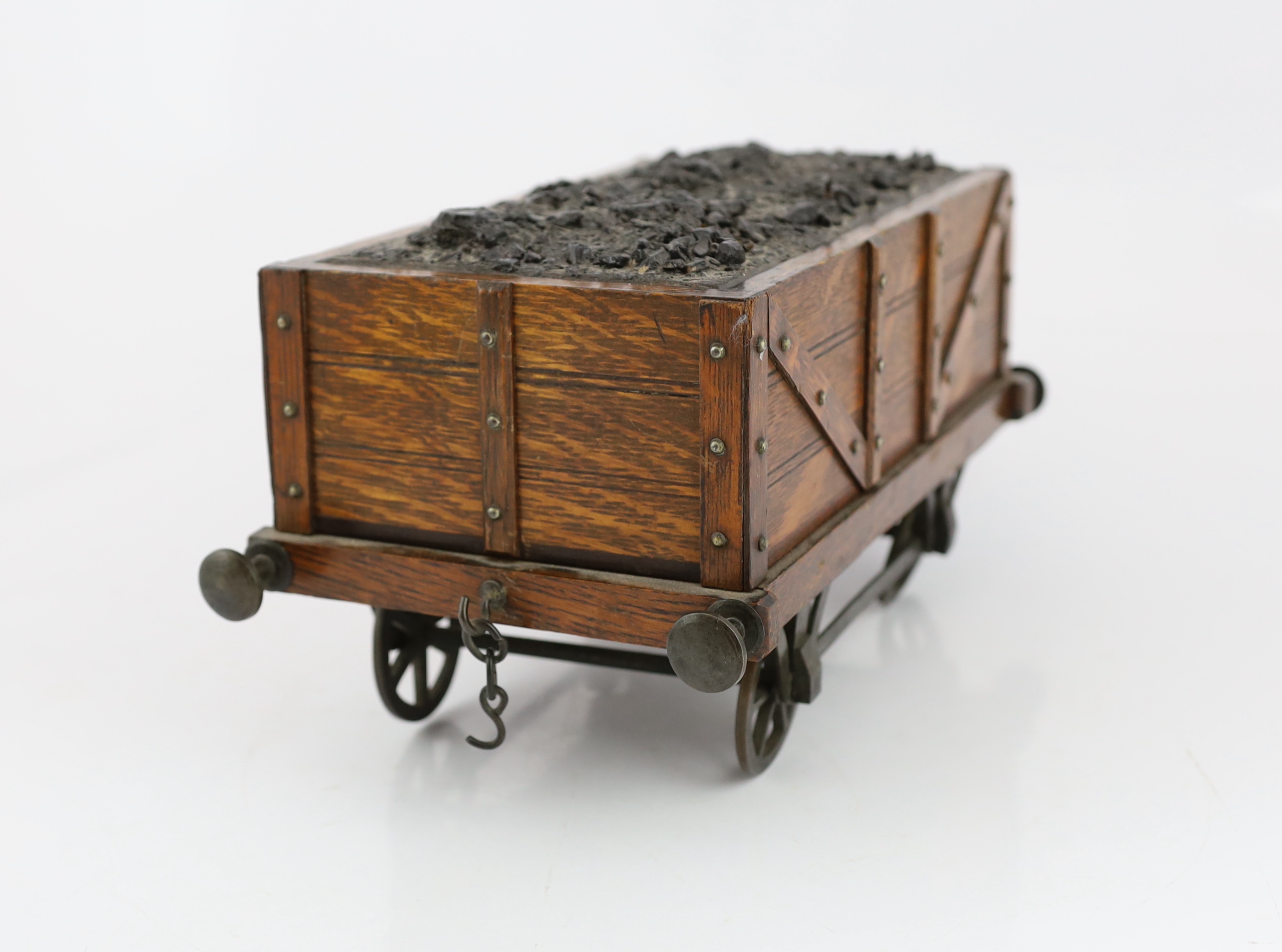 An Edwardian novelty oak smoker's compendium modelled as a railway tender, 34cm wide, 17cm deep, 17cm high